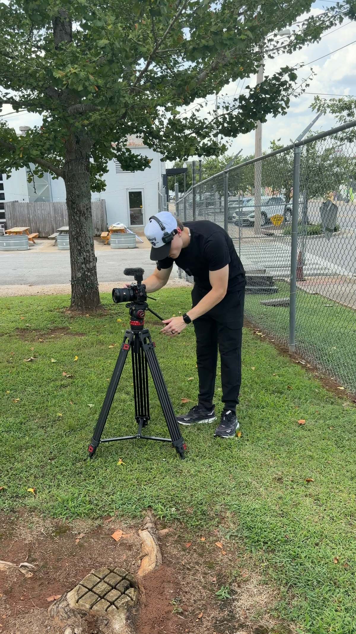 Setting up a tripod on location for an outdoor shoot